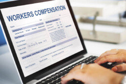 completing a workers' compensation form on a laptop
