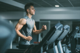 man running on treadmill in a fitness center